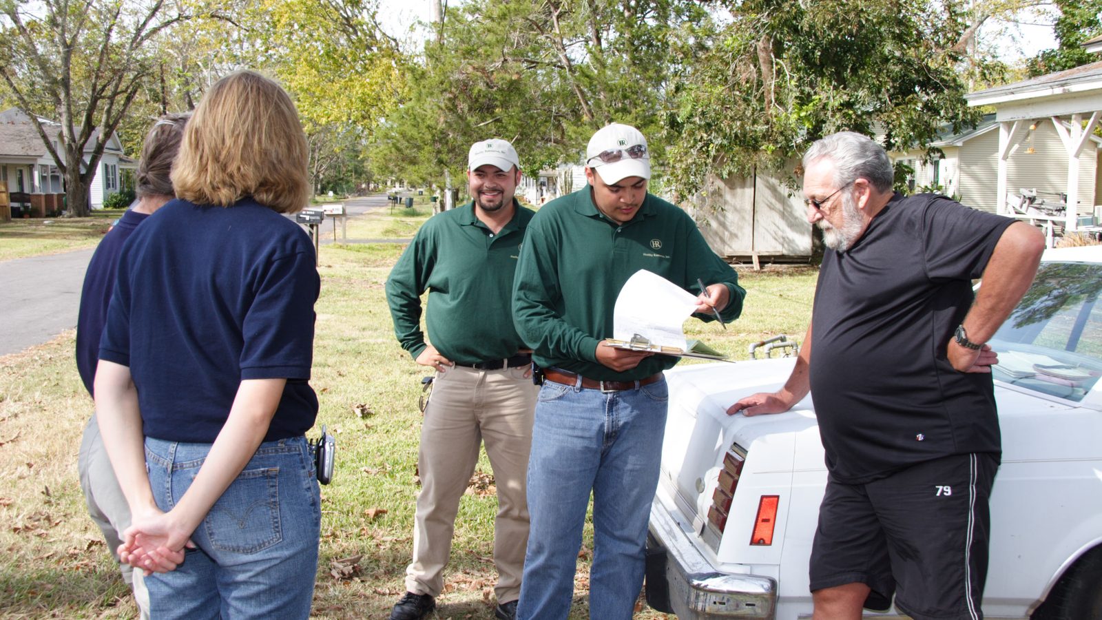 Inspectors reviewing damage paperwork with homeowners in Texas