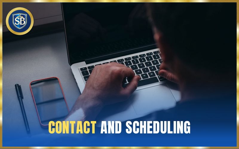 Hands typing on a laptop with a phone alongside to request a free inspection — contact and scheduling