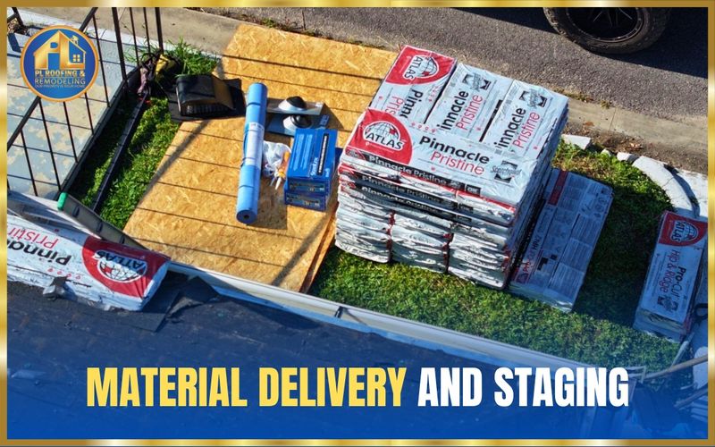 Shingle bundles, underlayment, and roofing supplies staged neatly on protective boards beside the driveway — material delivery and staging