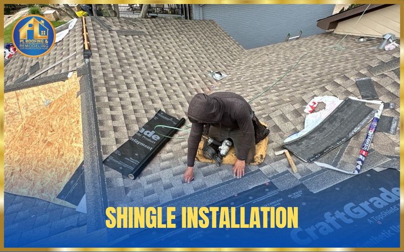 Roofer fastening new architectural shingles with a nail gun during a roof replacement — shingle installation